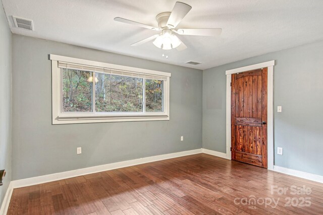 231 Highlands Loop, Maggie Valley, NC 28751 - spare room with wood finished floors, baseboards, and a ceiling fan