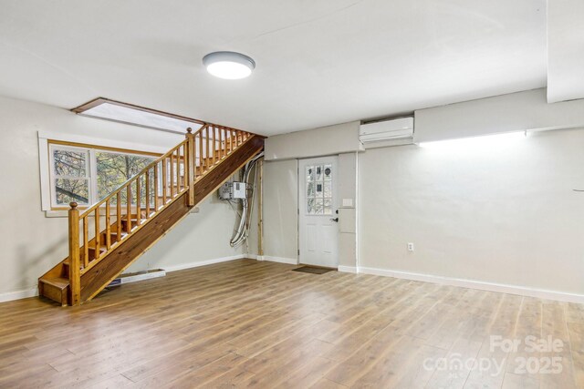 231 Highlands Loop, Maggie Valley, NC 28751 - basement with a wall mounted AC, baseboards, stairs, and wood finished floors