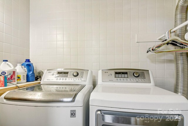 231 Highlands Loop, Maggie Valley, NC 28751 - laundry room with tile walls and washer and clothes dryer