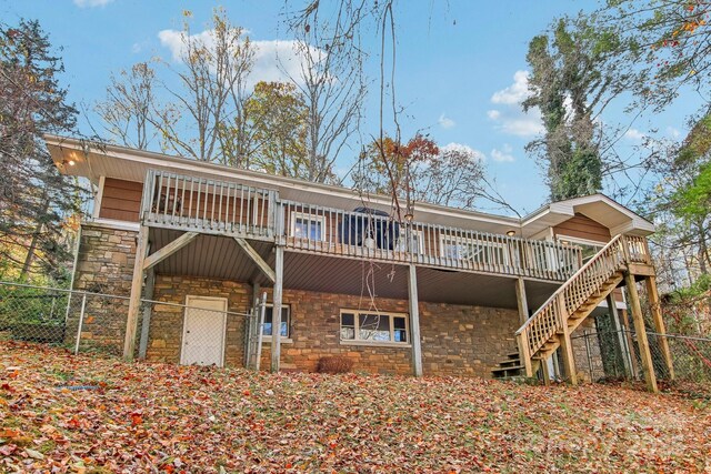 231 Highlands Loop, Maggie Valley, NC 28751 - back of house with stone siding, a deck, and stairway