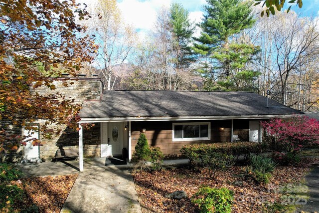 231 Highlands Loop, Maggie Valley, NC 28751 - ranch-style home with roof with shingles, stone siding, and a chimney