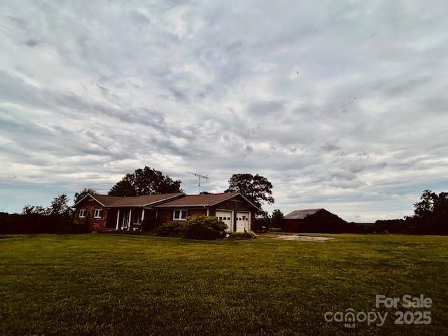 6714 Old Shelby Rd, Vale, NC 28168 - view of front facade with an attached garage and a front yard