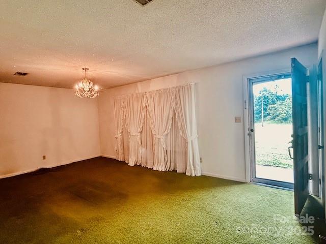 6714 Old Shelby Rd, Vale, NC 28168 - carpeted spare room with a chandelier, a textured ceiling, and baseboards
