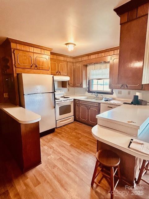 6714 Old Shelby Rd, Vale, NC 28168 - kitchen with white appliances, under cabinet range hood, a sink, and light countertops