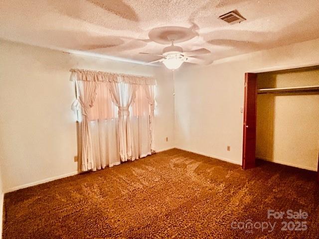 6714 Old Shelby Rd, Vale, NC 28168 - unfurnished bedroom featuring carpet flooring, a textured ceiling, a ceiling fan, and baseboards