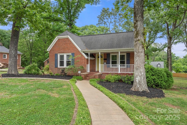 725 W Graham St, Shelby, NC 28150 - view of front of property with a porch, a front lawn, brick siding, and a shingled roof