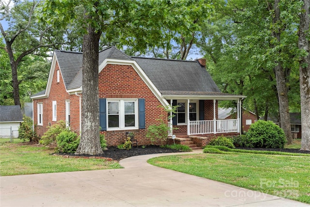725 W Graham St, Shelby, NC 28150 - view of front of property with a porch, brick siding, a front yard, and a shingled roof