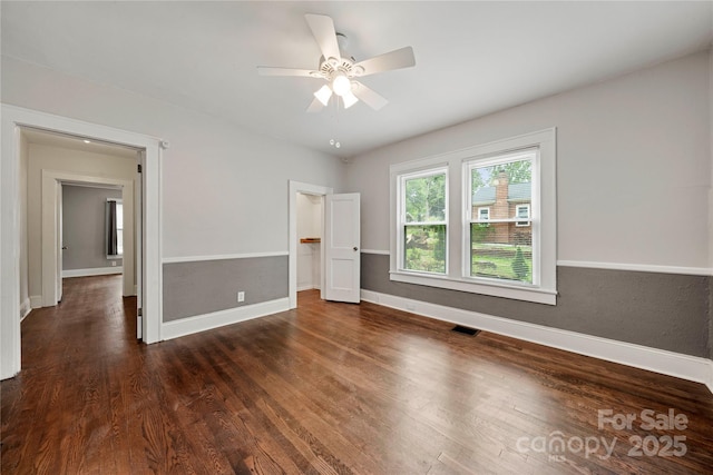 725 W Graham St, Shelby, NC 28150 - unfurnished bedroom featuring wood finished floors, a spacious closet, baseboards, and a ceiling fan