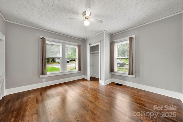 725 W Graham St, Shelby, NC 28150 - unfurnished bedroom with multiple windows, ornamental molding, wood-type flooring, a textured ceiling, and a closet