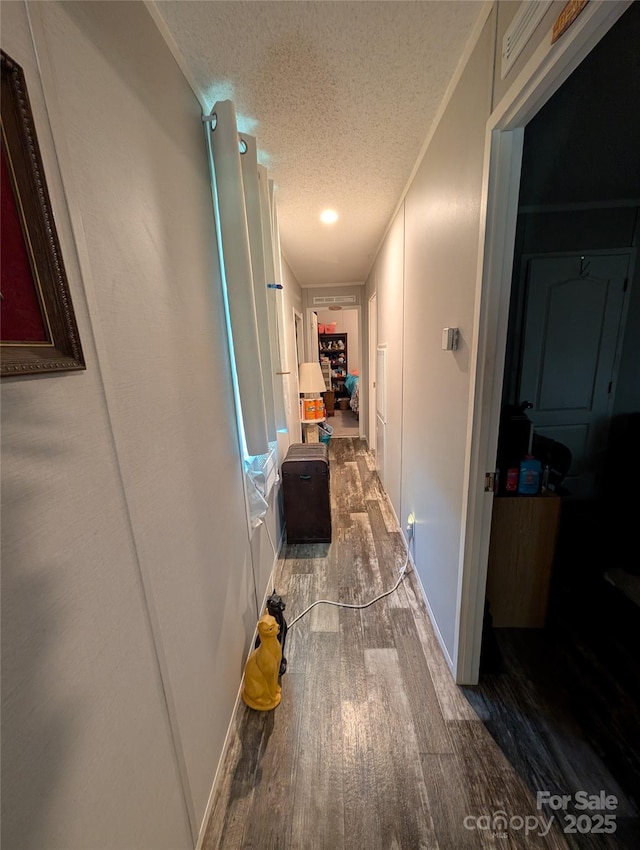 8827 Spring Meadow Dr, Hickory, NC 28601 - hallway featuring wood finished floors, a textured ceiling, and baseboards