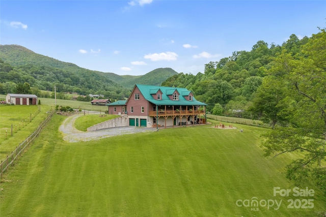 101 Trinity Dr, Clyde, NC 28721 - back of property featuring dirt driveway, a deck with mountain view, a view of countryside, and a garage
