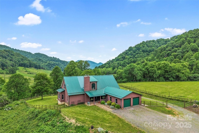 101 Trinity Dr, Clyde, NC 28721 - view of front of home with a chimney, an attached garage, driveway, a view of rural / pastoral area, and a wooded view