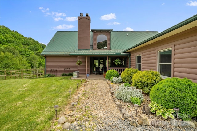 101 Trinity Dr, Clyde, NC 28721 - rear view of house with faux log siding, a chimney, metal roof, and a patio area
