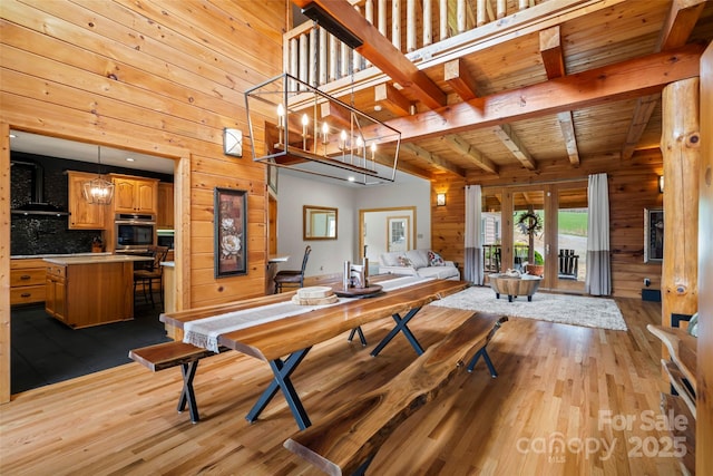 101 Trinity Dr, Clyde, NC 28721 - dining room with wood walls, wood finished floors, beamed ceiling, and french doors