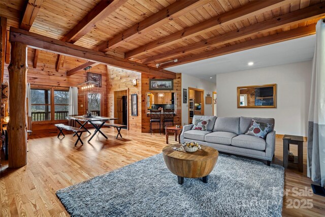 101 Trinity Dr, Clyde, NC 28721 - living area with light wood finished floors, wood walls, and wooden ceiling with exposed beams