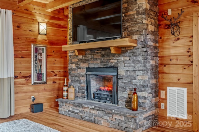 101 Trinity Dr, Clyde, NC 28721 - unfurnished living room with wood finished floors, wooden walls, a fireplace, and beam ceiling