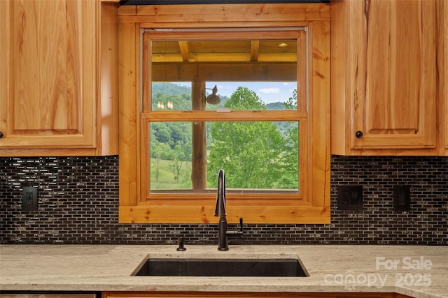 101 Trinity Dr, Clyde, NC 28721 - kitchen with a sink, tasteful backsplash, and light stone counters