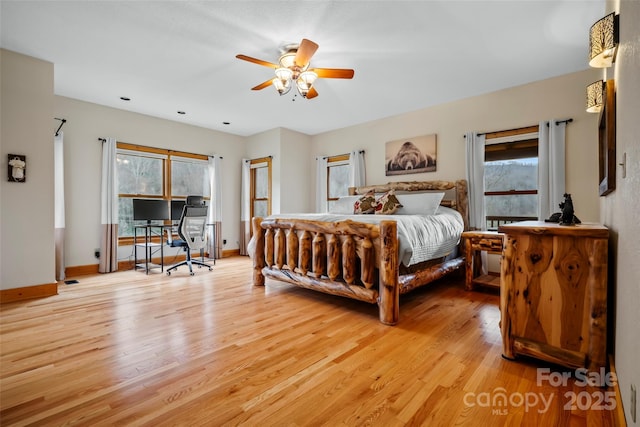 101 Trinity Dr, Clyde, NC 28721 - bedroom featuring light wood finished floors, a desk, baseboards, and ceiling fan