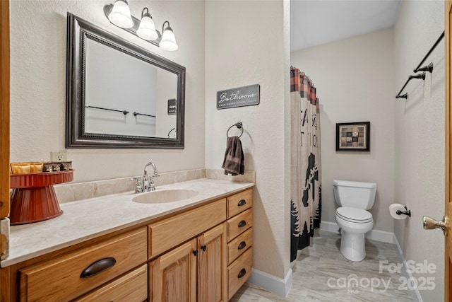 101 Trinity Dr, Clyde, NC 28721 - bathroom with toilet, vanity, baseboards, and a shower with shower curtain