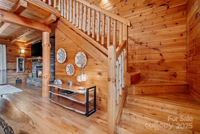 101 Trinity Dr, Clyde, NC 28721 - stairs with wooden walls, wood finished floors, a fireplace, and wood ceiling with exposed beams