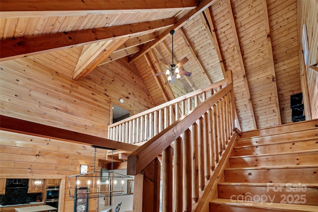 101 Trinity Dr, Clyde, NC 28721 - stairs with high vaulted ceiling, wooden walls, a chandelier, wood ceiling with exposed beams, and ceiling fan