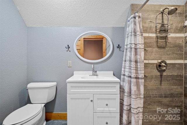 101 Trinity Dr, Clyde, NC 28721 - full bathroom featuring tiled shower, vanity, toilet, vaulted ceiling, and a textured wall