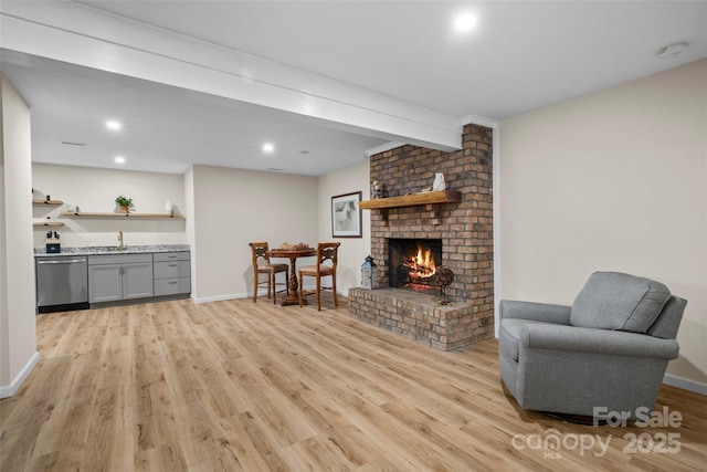 101 Trinity Dr, Clyde, NC 28721 - living area with light wood-style flooring, a brick fireplace, recessed lighting, and baseboards