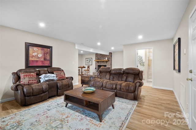 101 Trinity Dr, Clyde, NC 28721 - living room featuring light wood-style flooring, baseboards, recessed lighting, and a brick fireplace