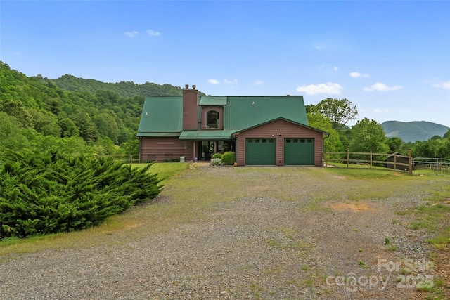 101 Trinity Dr, Clyde, NC 28721 - chalet / cabin featuring driveway, a garage, metal roof, a mountain view, and a chimney