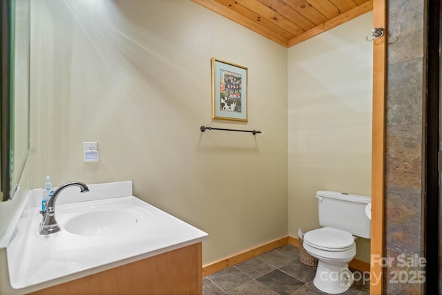 140 Spruce Hollow Rd, Beech Mountain, NC 28604 - bathroom featuring toilet, baseboards, wood ceiling, vanity, and stone finish floors