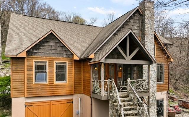 140 Spruce Hollow Rd, Beech Mountain, NC 28604 - rustic home with an attached garage, stairway, a chimney, and roof with shingles