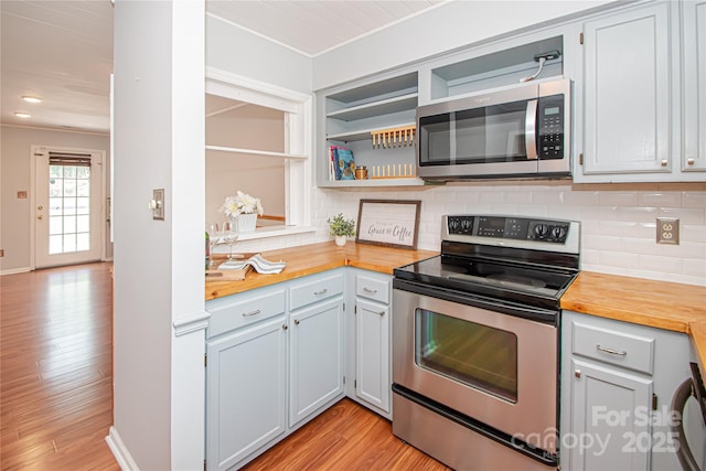 10945 Winterbourne Ct, Charlotte, NC 28277 - kitchen featuring stainless steel appliances, wooden counters, light wood finished floors, decorative backsplash, and recessed lighting