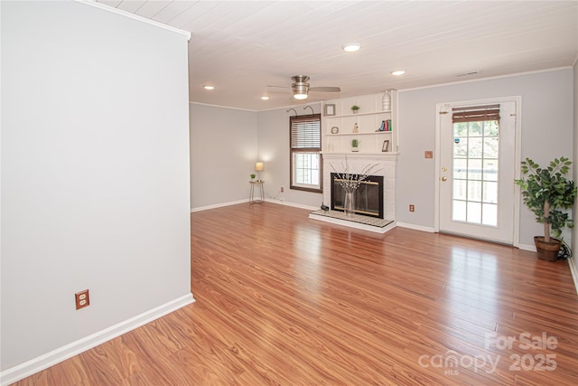 10945 Winterbourne Ct, Charlotte, NC 28277 - unfurnished living room with crown molding, plenty of natural light, a ceiling fan, baseboards, and a premium fireplace