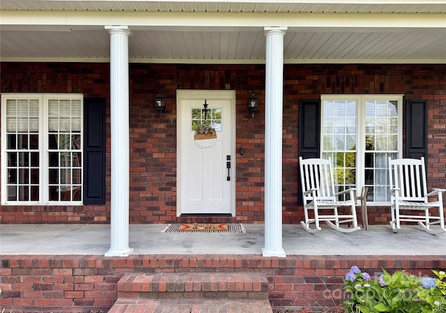 4230 Berry Hill Ct, Concord, NC 28025 - view of exterior entry featuring a porch and brick siding