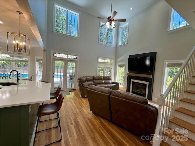 4230 Berry Hill Ct, Concord, NC 28025 - living room with a glass covered fireplace, stairway, ornamental molding, healthy amount of natural light, and a towering ceiling