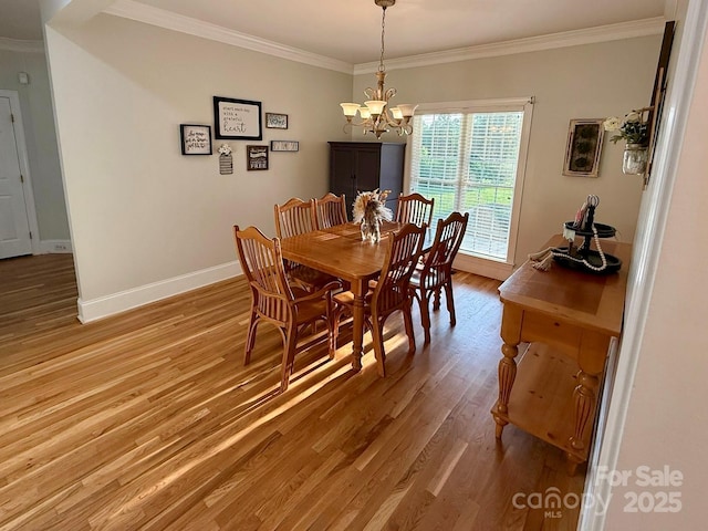 4230 Berry Hill Ct, Concord, NC 28025 - dining area with crown molding, light wood finished floors, and a chandelier