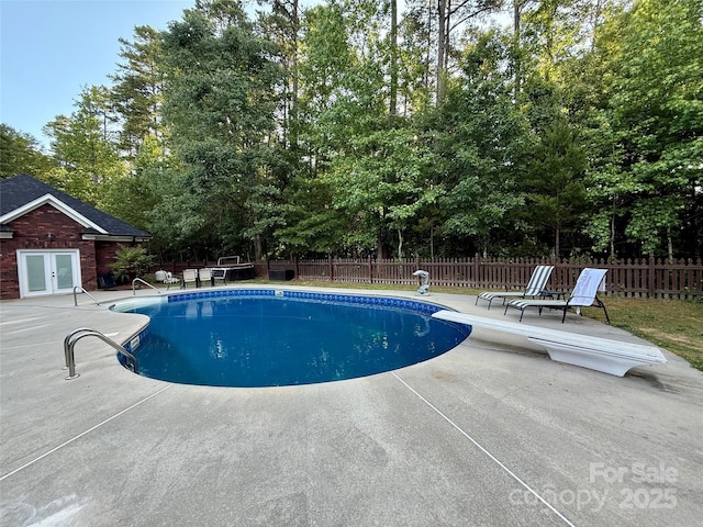 4230 Berry Hill Ct, Concord, NC 28025 - view of pool with a patio area, french doors, a diving board, and view of scattered trees