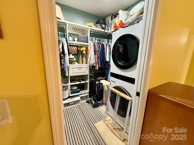 4230 Berry Hill Ct, Concord, NC 28025 - laundry room featuring estacked washer and dryer and carpet