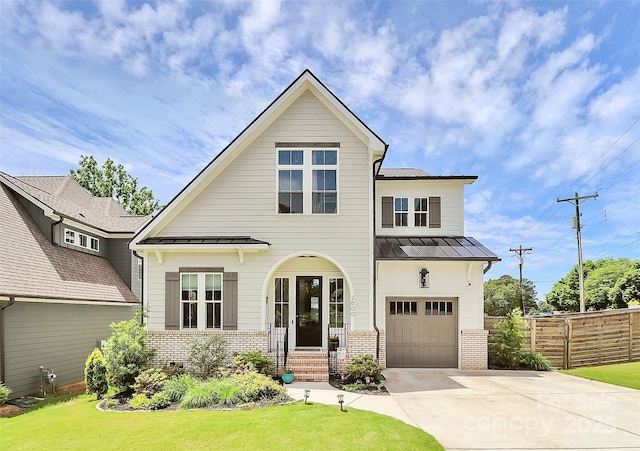 2600 Palm Ave, Charlotte, NC 28205 - view of front of home featuring a standing seam roof, brick siding, driveway, and metal roof