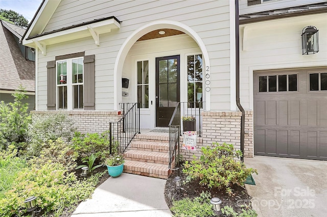 2600 Palm Ave, Charlotte, NC 28205 - view of exterior entry featuring brick siding and a garage