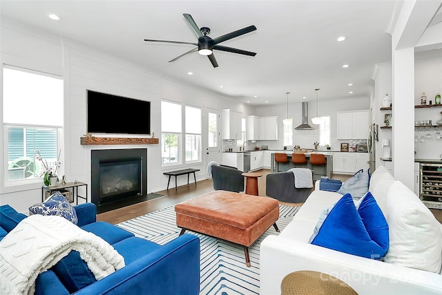 2600 Palm Ave, Charlotte, NC 28205 - living room with a ceiling fan, a large fireplace, recessed lighting, wood finished floors, and beverage cooler