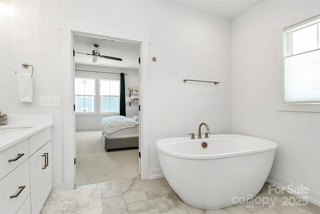 2600 Palm Ave, Charlotte, NC 28205 - bathroom featuring vanity, a soaking tub, ensuite bath, baseboards, and a ceiling fan