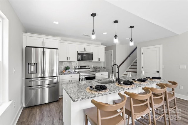 2906 Swicegood Rd, Linwood, NC 27299 - kitchen featuring stainless steel appliances, a sink, baseboards, white cabinets, and dark wood finished floors