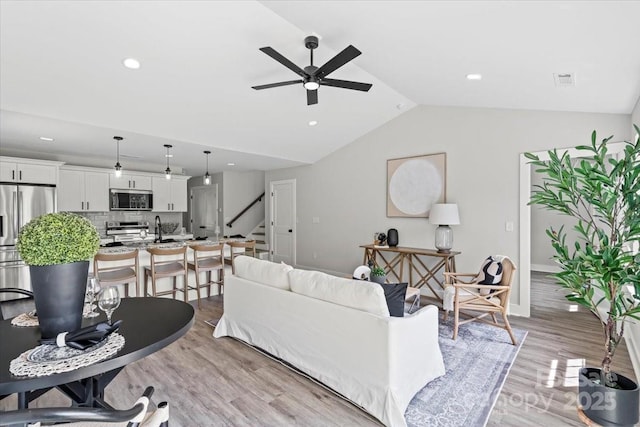 2906 Swicegood Rd, Linwood, NC 27299 - living area with ceiling fan, light wood-type flooring, stairway, vaulted ceiling, and recessed lighting