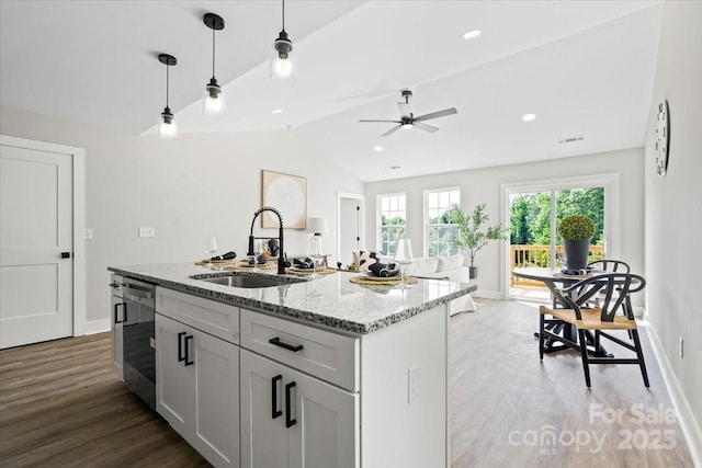 2906 Swicegood Rd, Linwood, NC 27299 - kitchen with a sink, light wood finished floors, baseboards, light stone counters, and vaulted ceiling