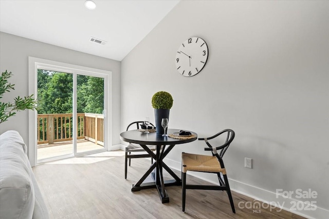 2906 Swicegood Rd, Linwood, NC 27299 - dining room featuring vaulted ceiling, light wood finished floors, and baseboards