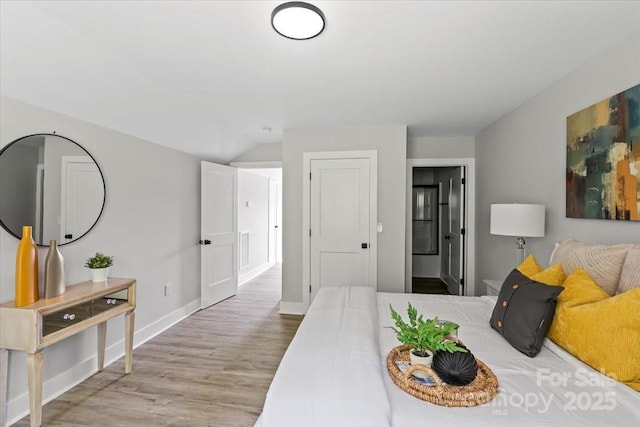 2906 Swicegood Rd, Linwood, NC 27299 - bedroom featuring wood finished floors, baseboards, and lofted ceiling
