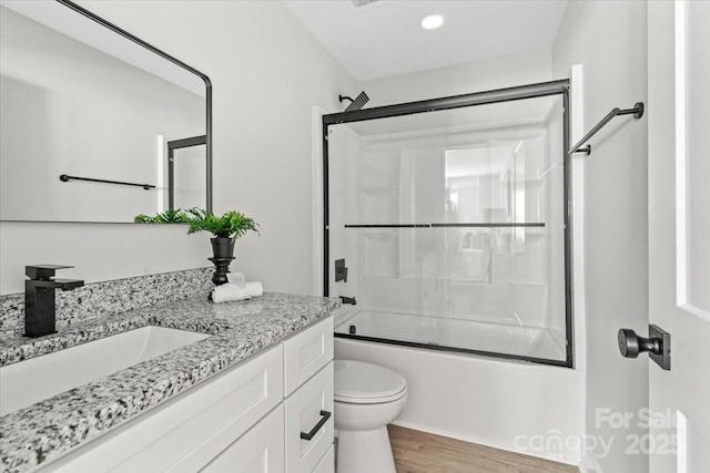 2906 Swicegood Rd, Linwood, NC 27299 - bathroom with vanity, toilet, enclosed tub / shower combo, wood finished floors, and recessed lighting
