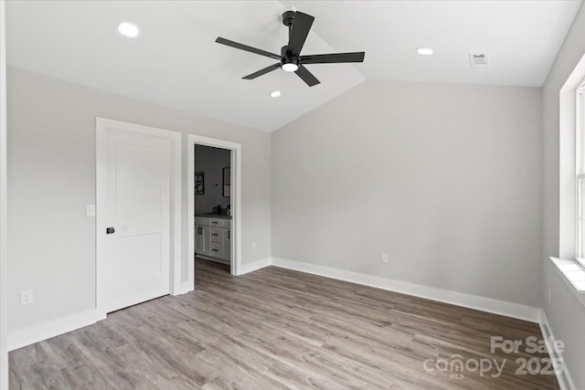 2906 Swicegood Rd, Linwood, NC 27299 - unfurnished bedroom featuring lofted ceiling, wood finished floors, recessed lighting, ensuite bathroom, and baseboards