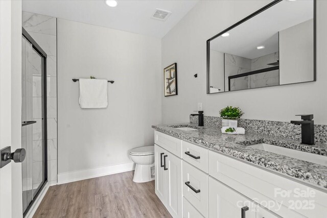 2906 Swicegood Rd, Linwood, NC 27299 - bathroom with toilet, double vanity, a shower stall, baseboards, and recessed lighting